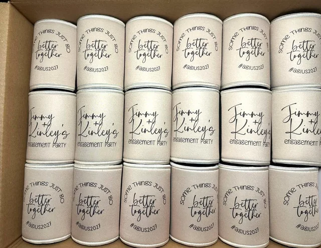 A box of cream stubby coolers printed for Jimmy and Kinley's engagement party